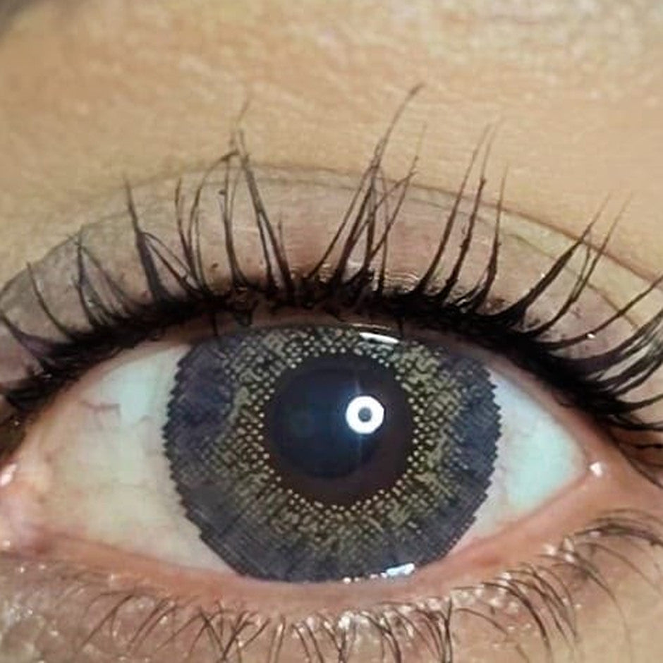 Gray cosmetic coloured contact lens worn on the eye (zero power)