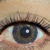 Gray cosmetic coloured contact lens worn on the eye (zero power)